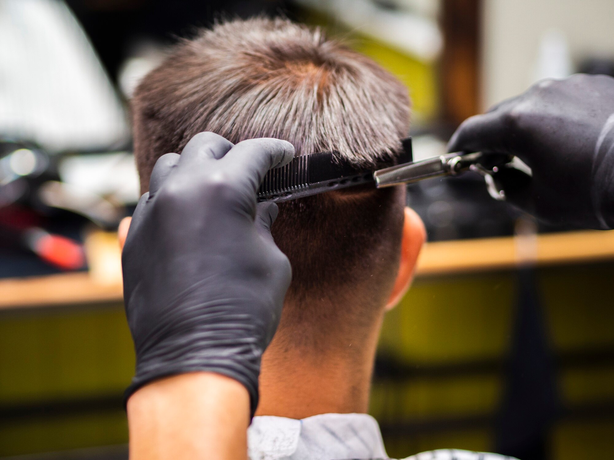 close up man getting haircut from 23 2148257033